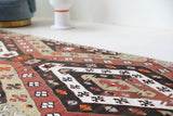 Vintage Turkish runner rug in a living room setting, pile rug, Turkish rug, vintage rug, portland, rug shop, bright colors, wild shaman, soft rug, bold color, Portland, Oregon, rug store, rug shop, local shop, antique rug