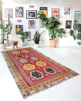 Vintage kilim rug in room decor setting, old rug, antique rug, pastel colors, faded colors, Turkish rug, vintage rug, soft rug, Portland, Oregon, rug store, rug shop, local shop, bold colors, bright colors, faded colors