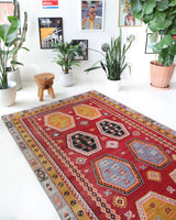 Vintage kilim rug in room decor setting, old rug, antique rug, pastel colors, faded colors, Turkish rug, vintage rug, soft rug, Portland, Oregon, rug store, rug shop, local shop, bold colors, bright colors, faded colors