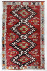 Vintage kilim rug in living room setting, old rug, antique rug, pastel colors, faded colors, Turkish rug, vintage rug, soft rug, Portland, Oregon, rug store, rug shop, local shop, earthy tones, earthy colors, warm colors