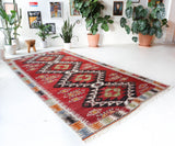 Vintage kilim rug in living room setting, old rug, antique rug, pastel colors, faded colors, Turkish rug, vintage rug, soft rug, Portland, Oregon, rug store, rug shop, local shop, earthy tones, earthy colors, warm colors