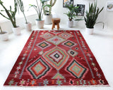 Vintage kilim rug in living room setting, old rug, antique rug, pastel colors, faded colors, Turkish rug, vintage rug, soft rug, Portland, Oregon, rug store, rug shop, local shop, earthy tones, earthy colors, warm colors