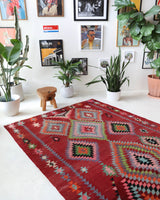 Vintage kilim rug in living room setting, old rug, antique rug, pastel colors, faded colors, Turkish rug, vintage rug, soft rug, Portland, Oregon, rug store, rug shop, local shop, earthy tones, earthy colors, warm colors