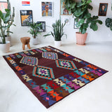 Vintage kilim rug in living room setting, old rug, antique rug, pastel colors, faded colors, Turkish rug, vintage rug, soft rug, Portland, Oregon, rug store, rug shop, local shop, earthy tones, earthy colors, warm colors