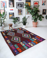 Vintage kilim rug in living room setting, old rug, antique rug, pastel colors, faded colors, Turkish rug, vintage rug, soft rug, Portland, Oregon, rug store, rug shop, local shop, earthy tones, earthy colors, warm colors