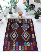 Vintage kilim rug in living room setting, old rug, antique rug, pastel colors, faded colors, Turkish rug, vintage rug, soft rug, Portland, Oregon, rug store, rug shop, local shop, earthy tones, earthy colors, warm colors