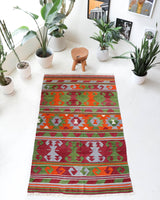 Vintage kilim rug in living room setting, old rug, antique rug, pastel colors, faded colors, Turkish rug, vintage rug, soft rug, Portland, Oregon, rug store, rug shop, local shop, earthy tones, earthy colors, warm colors