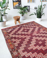 Vintage kilim rug in living room setting, old rug, antique rug, pastel colors, faded colors, Turkish rug, vintage rug, soft rug, Portland, Oregon, rug store, rug shop, local shop, earthy tones, earthy colors, warm colors