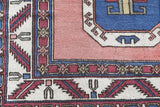 Vintage Turkish rug in a living room setting, Area rug in a living room setting, pile rug, Turkish rug, old rug, antique rug, pastel colors, faded colors, Turkish rug, vintage rug, soft rug, Portland, Oregon, rug store, rug shop, local shop, distressed rug, worn out rug