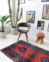 Vintage Turkish rug in a living room setting, pile rug, Turkish rug, vintage rug, portland, rug shop, bright colors, wild shaman, soft rug, bold color, Portland, Oregon, rug store, rug shop, local shop