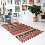 Vintage kilim rug in living room setting, old rug, antique rug, pastel colors, faded colors, Turkish rug, vintage rug, soft rug, Portland, Oregon, rug store, rug shop, local shop, earthy tones, earthy colors, warm colors