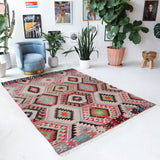Vintage kilim rug in room decor setting, old rug, antique rug, pastel colors, faded colors, Turkish rug, vintage rug, soft rug, Portland, Oregon, rug store, rug shop, local shop, bold colors, bright colors, faded colors