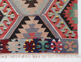 Vintage kilim rug in room decor setting, old rug, antique rug, pastel colors, faded colors, Turkish rug, vintage rug, soft rug, Portland, Oregon, rug store, rug shop, local shop, bold colors, bright colors, faded colors