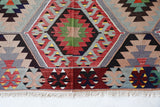 Vintage kilim rug in room decor setting, old rug, antique rug, pastel colors, faded colors, Turkish rug, vintage rug, soft rug, Portland, Oregon, rug store, rug shop, local shop, bold colors, bright colors, faded colors
