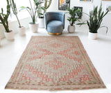Vintage kilim rug in living room setting, old rug, antique rug, pastel colors, faded colors, Turkish rug, vintage rug, soft rug, Portland, Oregon, rug store, rug shop, local shop, earthy tones, earthy colors, warm colors