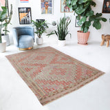 Vintage kilim rug in living room setting, old rug, antique rug, pastel colors, faded colors, Turkish rug, vintage rug, soft rug, Portland, Oregon, rug store, rug shop, local shop, earthy tones, earthy colors, warm colors