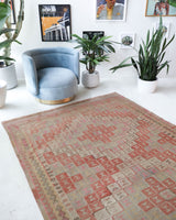 Vintage kilim rug in living room setting, old rug, antique rug, pastel colors, faded colors, Turkish rug, vintage rug, soft rug, Portland, Oregon, rug store, rug shop, local shop, earthy tones, earthy colors, warm colors