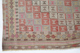 Vintage kilim rug in living room setting, old rug, antique rug, pastel colors, faded colors, Turkish rug, vintage rug, soft rug, Portland, Oregon, rug store, rug shop, local shop, earthy tones, earthy colors, warm colors
