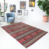 Vintage kilim rug in living room setting, old rug, antique rug, pastel colors, faded colors, Turkish rug, vintage rug, soft rug, Portland, Oregon, rug store, rug shop, local shop, earthy tones, earthy colors, warm colors