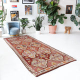 Vintage kilim rug in living room setting, old rug, antique rug, pastel colors, faded colors, Turkish rug, vintage rug, soft rug, Portland, Oregon, rug store, rug shop, local shop, earthy tones, earthy colors, warm colors