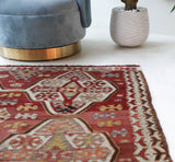 Vintage kilim rug in living room setting, old rug, antique rug, pastel colors, faded colors, Turkish rug, vintage rug, soft rug, Portland, Oregon, rug store, rug shop, local shop, earthy tones, earthy colors, warm colors