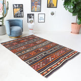 Vintage kilim rug in room decor setting, old rug, antique rug, pastel colors, faded colors, Turkish rug, vintage rug, soft rug, Portland, Oregon, rug store, rug shop, local shop, bold colors, bright colors, faded colors