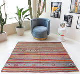 Vintage kilim rug in room decor setting, old rug, antique rug, pastel colors, faded colors, Turkish rug, vintage rug, soft rug, Portland, Oregon, rug store, rug shop, local shop, bold colors, bright colors, faded colors