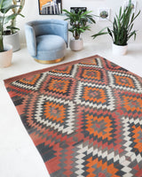 Vintage kilim rug in room decor setting, old rug, antique rug, pastel colors, faded colors, Turkish rug, vintage rug, soft rug, Portland, Oregon, rug store, rug shop, local shop, bold colors, bright colors, faded colors