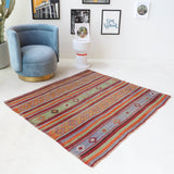 Vintage kilim rug in room decor setting, old rug, antique rug, pastel colors, faded colors, Turkish rug, vintage rug, soft rug, Portland, Oregon, rug store, rug shop, local shop, bold colors, bright colors, faded colors