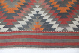 Vintage kilim rug in room decor setting, old rug, antique rug, pastel colors, faded colors, Turkish rug, vintage rug, soft rug, Portland, Oregon, rug store, rug shop, local shop, bold colors, bright colors, faded colors