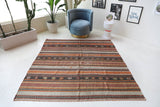 Vintage kilim rug in living room setting, old rug, antique rug, pastel colors, faded colors, Turkish rug, vintage rug, soft rug, Portland, Oregon, rug store, rug shop, local shop, earthy tones, earthy colors, warm colors