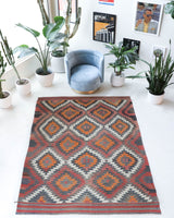 Vintage kilim rug in room decor setting, old rug, antique rug, pastel colors, faded colors, Turkish rug, vintage rug, soft rug, Portland, Oregon, rug store, rug shop, local shop, bold colors, bright colors, faded colors