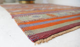 Vintage kilim rug in living room setting, old rug, antique rug, pastel colors, faded colors, Turkish rug, vintage rug, soft rug, Portland, Oregon, rug store, rug shop, local shop, earthy tones, earthy colors, warm colors