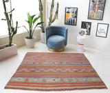 Vintage kilim rug in living room setting, old rug, antique rug, pastel colors, faded colors, Turkish rug, vintage rug, soft rug, Portland, Oregon, rug store, rug shop, local shop, earthy tones, earthy colors, warm colors