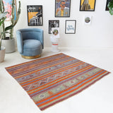 Vintage kilim rug in living room setting, old rug, antique rug, pastel colors, faded colors, Turkish rug, vintage rug, soft rug, Portland, Oregon, rug store, rug shop, local shop, earthy tones, earthy colors, warm colors