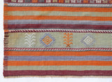 Vintage kilim rug in living room setting, old rug, antique rug, pastel colors, faded colors, Turkish rug, vintage rug, soft rug, Portland, Oregon, rug store, rug shop, local shop, earthy tones, earthy colors, warm colors