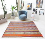 Vintage kilim rug in living room setting, old rug, antique rug, pastel colors, faded colors, Turkish rug, vintage rug, soft rug, Portland, Oregon, rug store, rug shop, local shop, earthy tones, earthy colors, warm colors
