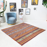 Vintage kilim rug in living room setting, old rug, antique rug, pastel colors, faded colors, Turkish rug, vintage rug, soft rug, Portland, Oregon, rug store, rug shop, local shop, earthy tones, earthy colors, warm colors