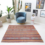 Vintage kilim rug in living room setting, old rug, antique rug, pastel colors, faded colors, Turkish rug, vintage rug, soft rug, Portland, Oregon, rug store, rug shop, local shop, earthy tones, earthy colors, warm colors