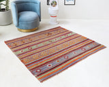 Vintage kilim rug in living room setting, old rug, antique rug, pastel colors, faded colors, Turkish rug, vintage rug, soft rug, Portland, Oregon, rug store, rug shop, local shop, earthy tones, earthy colors, warm colors