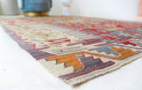 Vintage kilim rug in room decor setting, old rug, antique rug, pastel colors, faded colors, Turkish rug, vintage rug, soft rug, Portland, Oregon, rug store, rug shop, local shop, bold colors, bright colors, faded colors