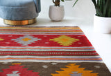 Vintage kilim rug in living room setting, bright colors, wild shaman, soft rug, bold color, Portland, Oregon, rug store, rug shop, local shop, vintage rug, modern kilim, warm colors