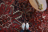 Antique Persian area rug in a living room setting, pile rug, vintage rug, portland, rug shop, bright colors, wild shaman, soft rug, bold color, Portland, Oregon, rug store, rug shop, local shop, antique rug, Persian rug, handmade rug, wool rug, distressed rug