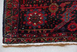 Antique Persian area rug in a living room setting, pile rug, vintage rug, portland, rug shop, bright colors, wild shaman, soft rug, bold color, Portland, Oregon, rug store, rug shop, local shop, antique rug, Persian rug, handmade rug, wool rug, distressed rug