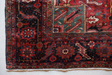 Antique Persian area rug in a living room setting, pile rug, vintage rug, portland, rug shop, bright colors, wild shaman, soft rug, bold color, Portland, Oregon, rug store, rug shop, local shop, antique rug, Persian rug, handmade rug, wool rug, distressed rug