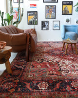 Antique Persian area rug in a living room setting, pile rug, vintage rug, portland, rug shop, bright colors, wild shaman, soft rug, bold color, Portland, Oregon, rug store, rug shop, local shop, antique rug, Persian rug, handmade rug, wool rug, distressed rug