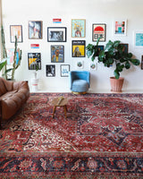Antique Persian area rug in a living room setting, pile rug, vintage rug, portland, rug shop, bright colors, wild shaman, soft rug, bold color, Portland, Oregon, rug store, rug shop, local shop, antique rug, Persian rug, handmade rug, wool rug, distressed rug