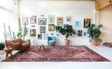 Antique Persian area rug in a living room setting, pile rug, vintage rug, portland, rug shop, bright colors, wild shaman, soft rug, bold color, Portland, Oregon, rug store, rug shop, local shop, antique rug, Persian rug, handmade rug, wool rug, distressed rug