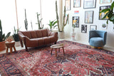 Antique Persian area rug in a living room setting, pile rug, vintage rug, portland, rug shop, bright colors, wild shaman, soft rug, bold color, Portland, Oregon, rug store, rug shop, local shop, antique rug, Persian rug, handmade rug, wool rug, distressed rug