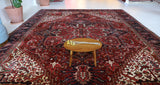 Antique Persian area rug in a living room setting, pile rug, vintage rug, portland, rug shop, bright colors, wild shaman, soft rug, bold color, Portland, Oregon, rug store, rug shop, local shop, antique rug, Persian rug, handmade rug, wool rug, distressed rug